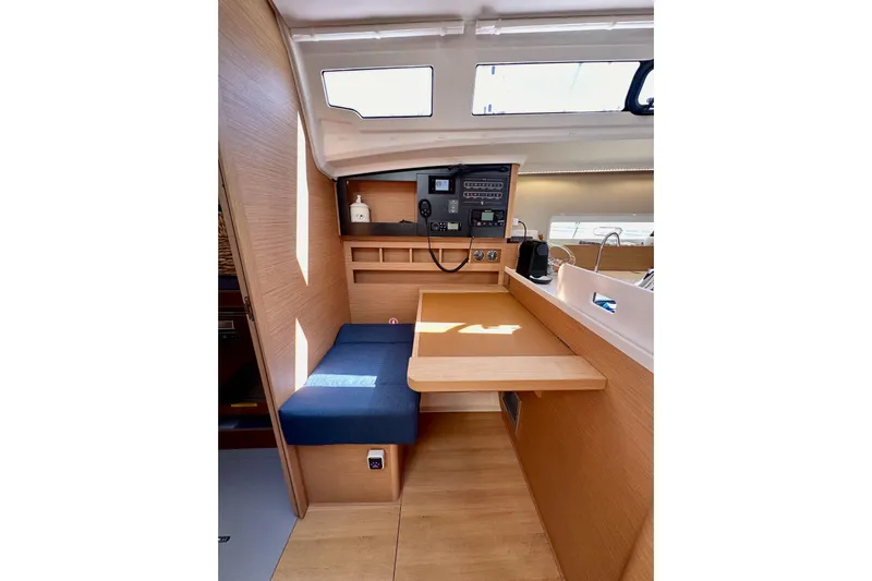 Best Day Ever Yacht Photos Pics Interior of 2022 Jeanneau Sun Odyssey 410 sailboat, featuring a compact navigation station.