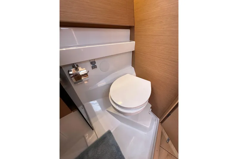 Best Day Ever Yacht Photos Pics Modern bathroom in 2022 Jeanneau Sun Odyssey 410 yacht, featuring sleek design and wood accents.