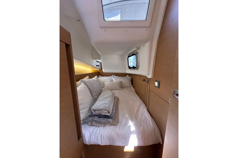 Best Day Ever Yacht Photos Pics Cozy cabin interior of 2022 Jeanneau Sun Odyssey 410 sailboat with skylight and bedding.