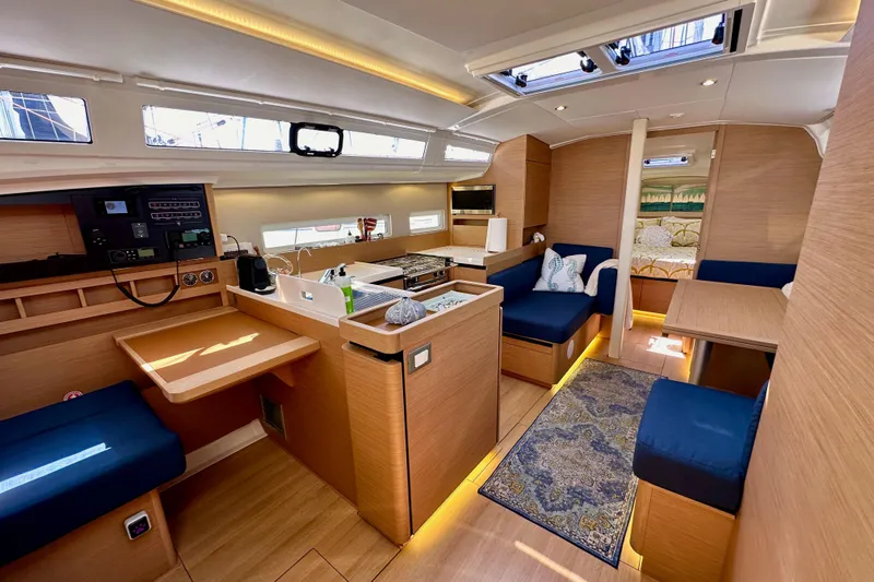 Best Day Ever Yacht Photos Pics Interior of 2022 Jeanneau Sun Odyssey 410 sailboat, featuring modern design and cozy seating.
