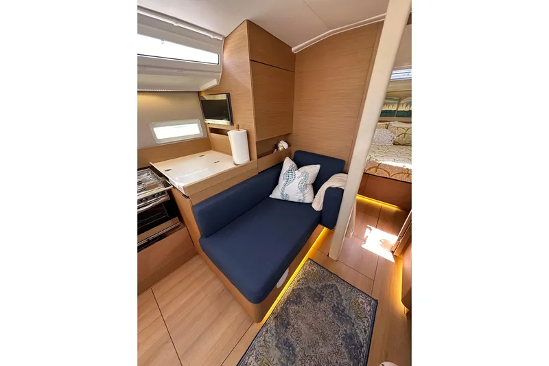 Best Day Ever Yacht Photos Pics Interior of 2022 Jeanneau Sun Odyssey 410 yacht with cozy seating and modern design.
