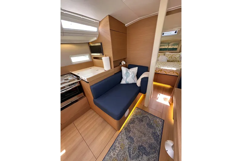Best Day Ever Yacht Photos Pics Interior of 2022 Jeanneau Sun Odyssey 410 yacht with cozy seating and modern design.
