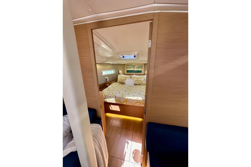 Best Day Ever Yacht Photos Pics Cozy cabin interior of 2022 Jeanneau Sun Odyssey 410 sailboat, featuring a comfortable bed.
