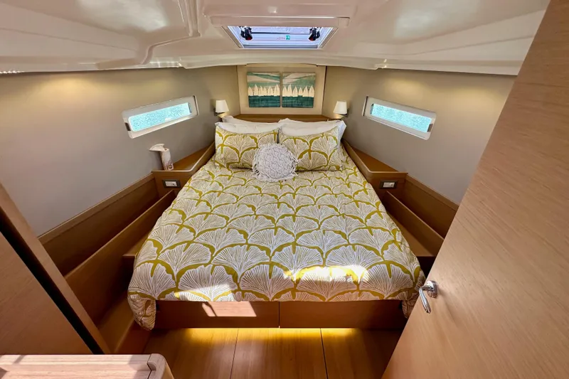 Best Day Ever Yacht Photos Pics Luxurious cabin interior of 2022 Jeanneau Sun Odyssey 410 yacht with stylish bedding.