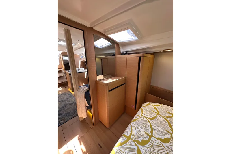 Best Day Ever Yacht Photos Pics Interior of 2022 Jeanneau Sun Odyssey 410 yacht, featuring modern wood cabinetry and skylights.