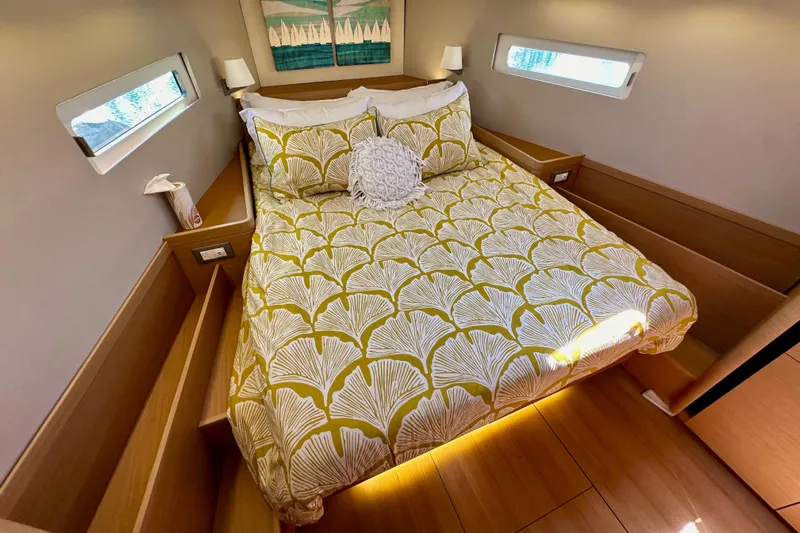 Best Day Ever Yacht Photos Pics Cozy cabin interior of 2022 Jeanneau Sun Odyssey 410 with stylish bedding and modern decor.