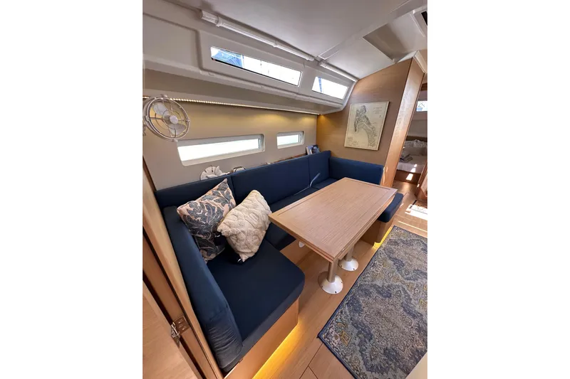 Best Day Ever Yacht Photos Pics Interior of 2022 Jeanneau Sun Odyssey 410 yacht with cozy seating and elegant decor.