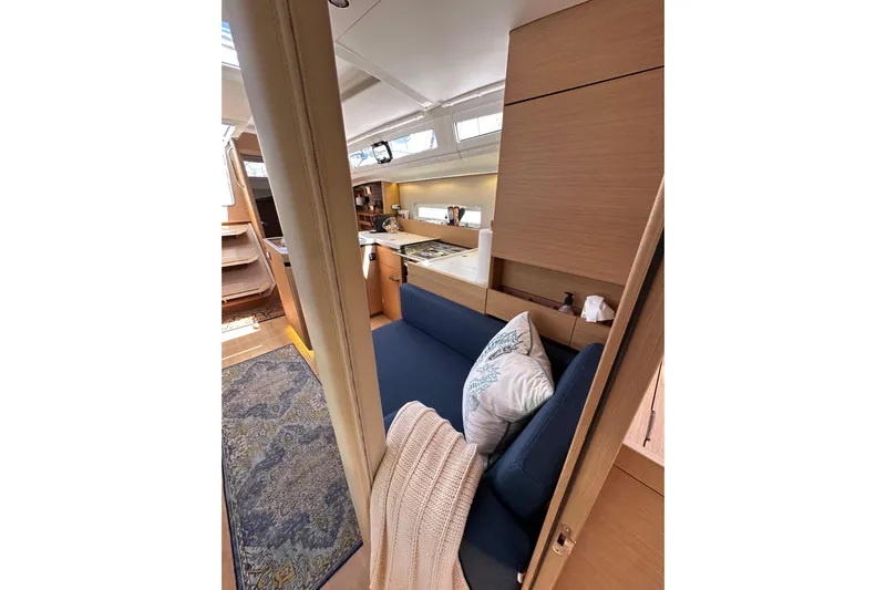 Best Day Ever Yacht Photos Pics Interior of 2022 Jeanneau Sun Odyssey 410 yacht, featuring cozy seating and modern design.