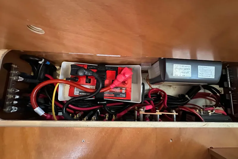 Best Day Ever Yacht Photos Pics Electrical system of 2022 Jeanneau Sun Odyssey 410 sailboat, featuring batteries and wiring.