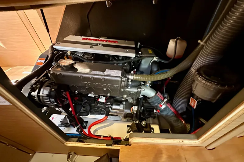 Best Day Ever Yacht Photos Pics Engine compartment of 2022 Jeanneau Sun Odyssey 410 sailboat, showcasing detailed mechanical components.