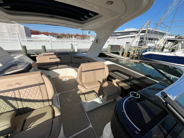 Knot On Call Yacht Photos Pics 2018 Sea Ray 310 SLX boat interior with luxurious seating at a marina.