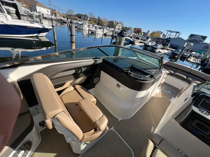 Knot On Call Yacht Photos Pics 2018 Sea Ray 310 SLX boat interior with tan seating, docked at a marina.