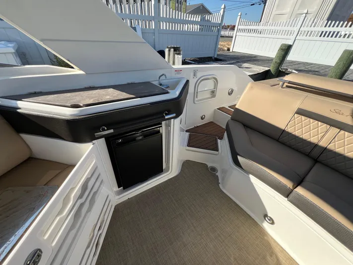 Knot On Call Yacht Photos Pics 2018 Sea Ray 310 SLX interior with seating, kitchenette, and steps.
