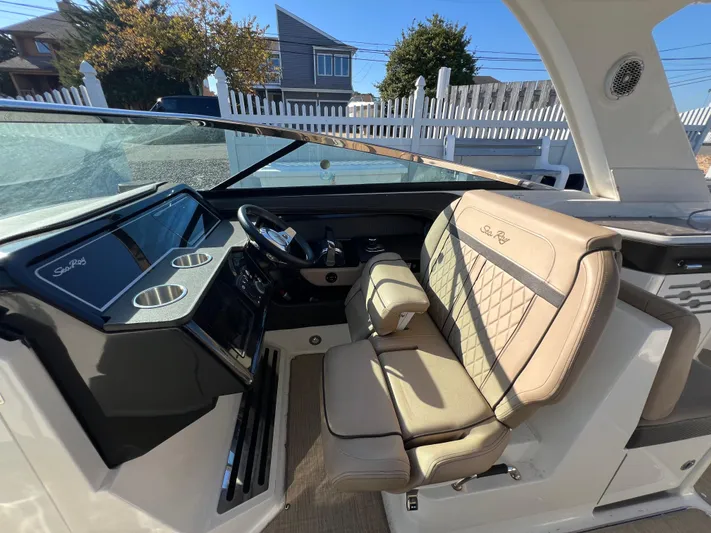 Knot On Call Yacht Photos Pics 2018 Sea Ray 310 SLX boat interior with beige seating and modern dashboard.