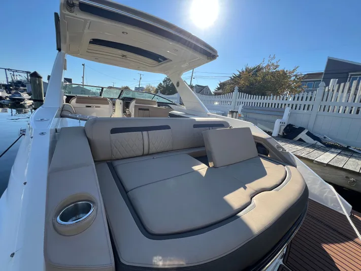 Knot On Call Yacht Photos Pics 2018 Sea Ray 310 SLX boat with spacious seating and sunshade, docked under clear skies.