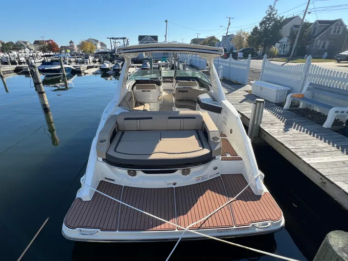 Knot On Call Yacht Photos Pics 2018 Sea Ray 310 SLX boat docked at a marina, showcasing spacious seating and sleek design.