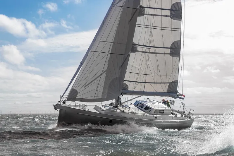 Bv3 Yacht Photos Pics Sailing yacht Bestevaer 36, 2023 model, navigating through waves under a cloudy sky.