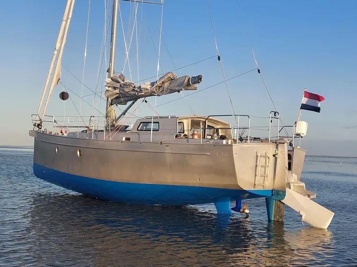 Bv3 Yacht Photos Pics Sailing yacht Bestevaer 36, 2023 model, anchored in calm waters with a flag.