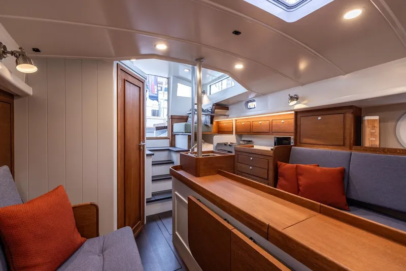 Bv3 Yacht Photos Pics Interior of 2023 Bestevaer 36 yacht, featuring cozy seating and modern wooden cabinetry.