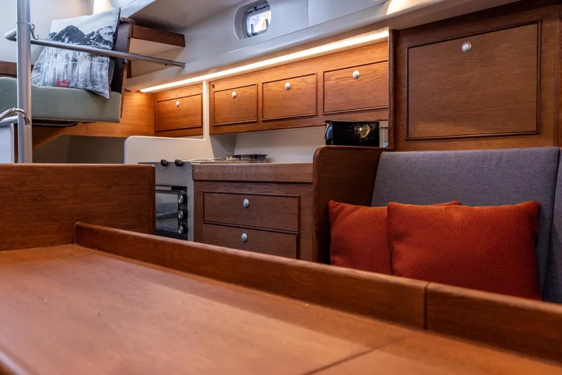 Bv3 Yacht Photos Pics Interior of 2023 Bestevaer 36 yacht with wooden cabinetry and cozy seating area.