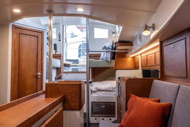 Bv3 Yacht Photos Pics Interior of 2023 Bestevaer 36 yacht, featuring cozy seating, wooden cabinetry, and modern lighting.