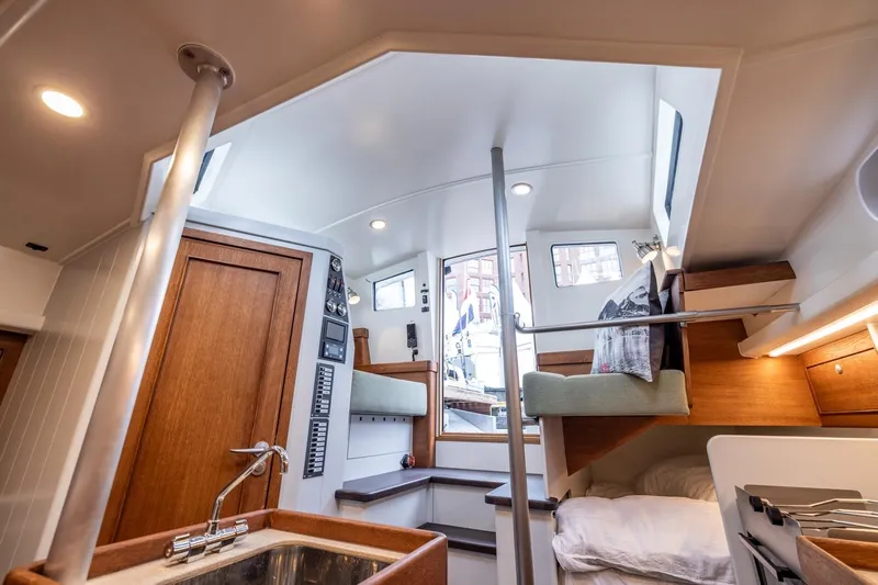 Bv3 Yacht Photos Pics Interior of 2023 Bestevaer 36 yacht, featuring modern design, wood accents, and cozy sleeping area.