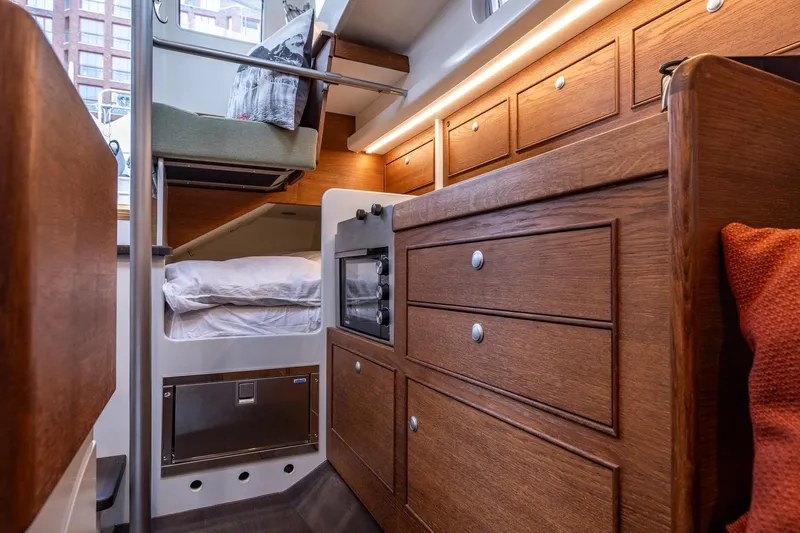 Bv3 Yacht Photos Pics Interior of 2023 Bestevaer 36 yacht with wooden cabinetry and cozy sleeping area.