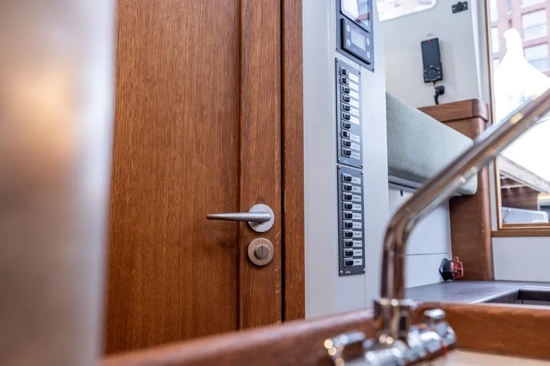 Bv3 Yacht Photos Pics Interior of 2023 Bestevaer 36 yacht, featuring wooden door, control panel, and modern sink.