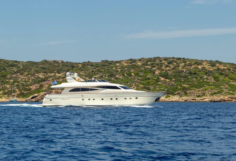  Yacht Photos Pics 2003 Canados 86 yacht cruising near a scenic coastline under a clear blue sky.