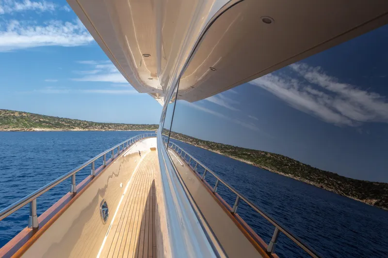  Yacht Photos Pics Luxurious 2003 Canados 86 yacht reflecting ocean and sky on a sunny day.