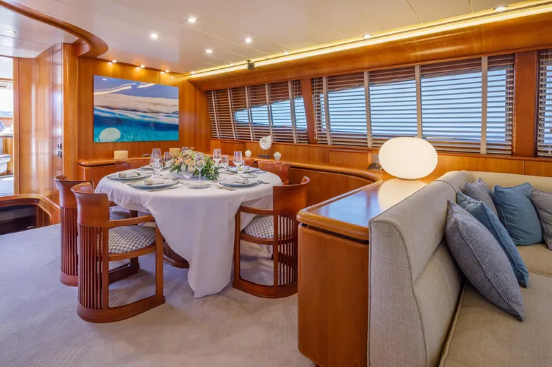  Yacht Photos Pics Luxurious dining area on 2003 Canados 86 yacht with elegant table setting and plush seating.