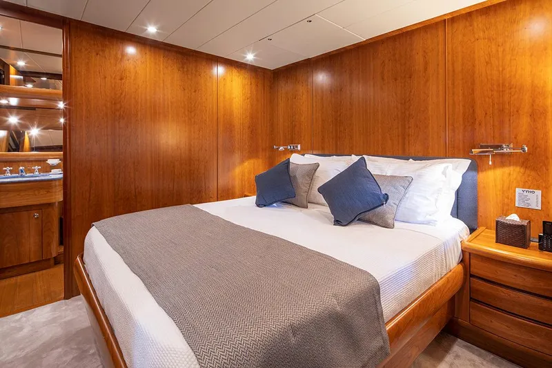  Yacht Photos Pics Luxurious bedroom interior on 2003 Canados 86 yacht with wooden paneling and cozy bedding.