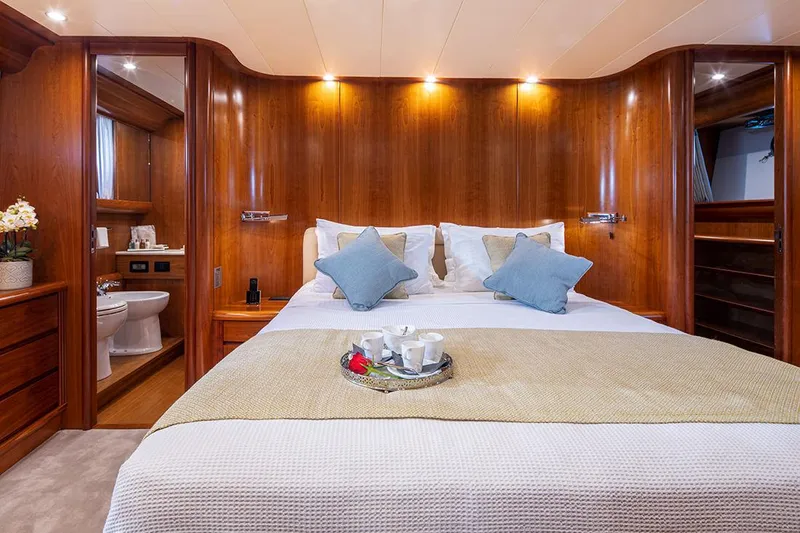  Yacht Photos Pics Luxurious bedroom interior on 2003 Canados 86 yacht with elegant wood paneling and cozy bedding.