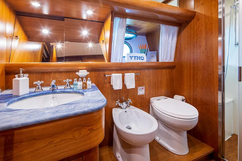  Yacht Photos Pics Luxurious bathroom on 2003 Canados 86 yacht with wooden accents and modern fixtures.