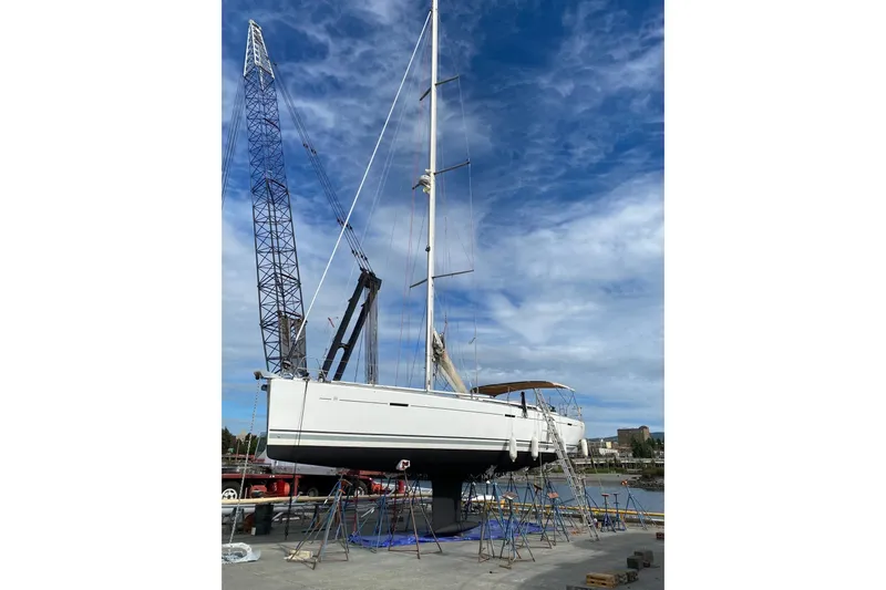 La Chiricana Yacht Photos Pics 2011 Dufour 525 Grand Large sailboat on dry dock with crane and blue sky.
