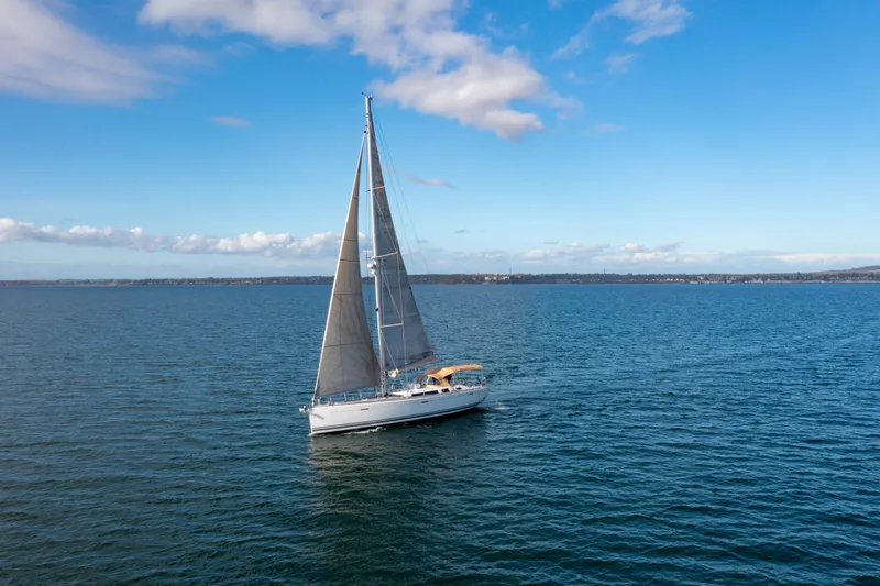 La Chiricana Yacht Photos Pics Sailing yacht Dufour 525 Grand Large 2011 on open sea under blue sky.
