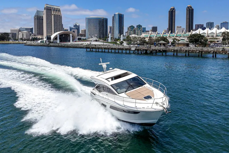  Yacht Photos Pics 2017 Sea Ray Sundancer 400 cruising in a city harbor with skyline backdrop.