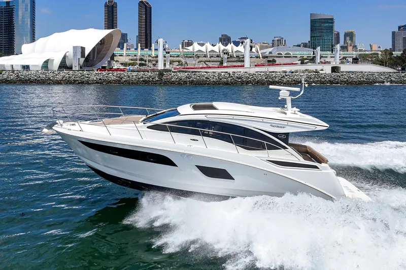  Yacht Photos Pics 2017 Sea Ray Sundancer 400 yacht cruising in a city harbor with modern skyline.