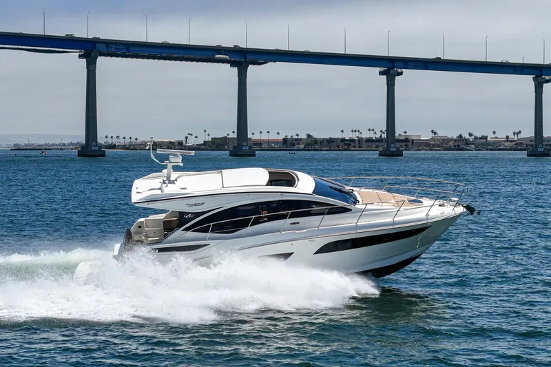  Yacht Photos Pics 2017 Sea Ray Sundancer 400 cruising under a bridge on a sunny day.
