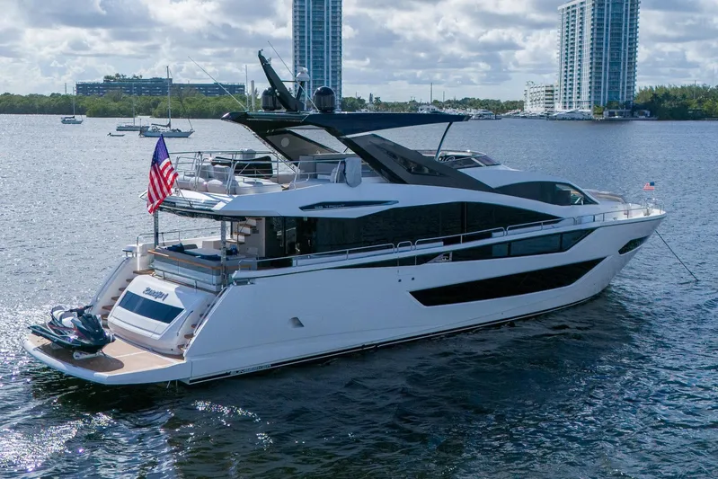 Ramaya 4 Yacht Photos Pics 2023 Sunseeker 88 Yacht cruising on a sunny day with city skyline backdrop.