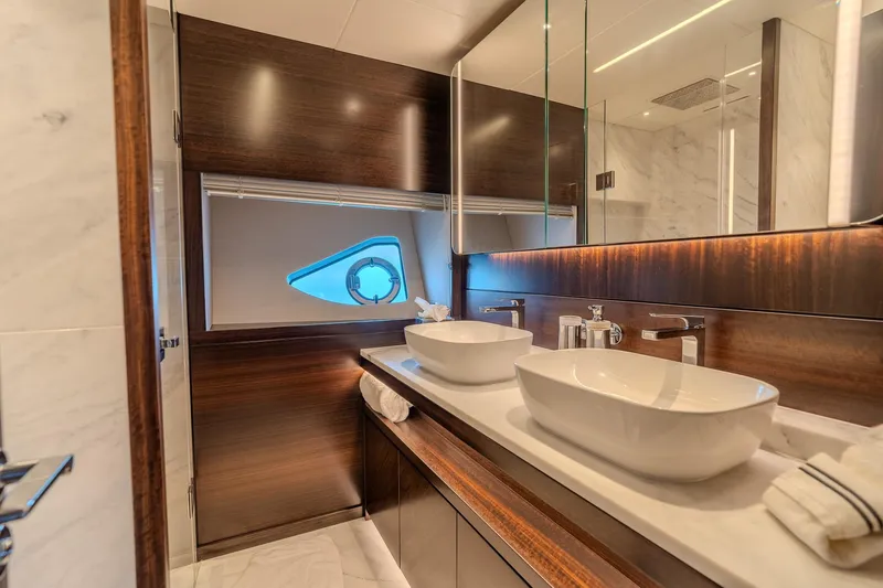Ramaya 4 Yacht Photos Pics Luxurious bathroom interior of 2023 Sunseeker 88 Yacht with dual sinks and elegant wood finishes.