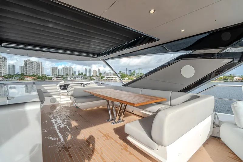 Ramaya 4 Yacht Photos Pics Luxurious Sunseeker 88 Yacht 2023 deck with modern seating and city skyline view.