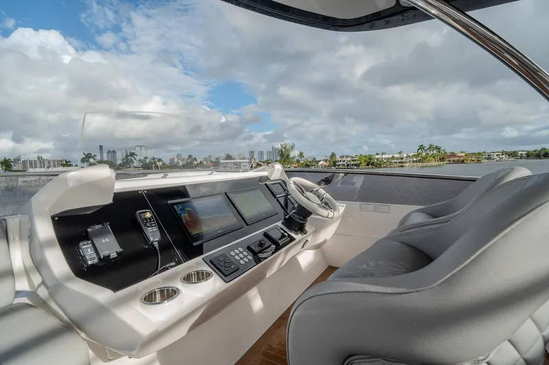 Ramaya 4 Yacht Photos Pics Luxurious helm of 2023 Sunseeker 88 Yacht with modern navigation equipment and plush seating.