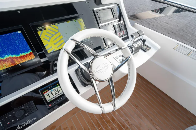 Ramaya 4 Yacht Photos Pics Control panel of 2023 Sunseeker 88 Yacht with advanced navigation displays and steering wheel.