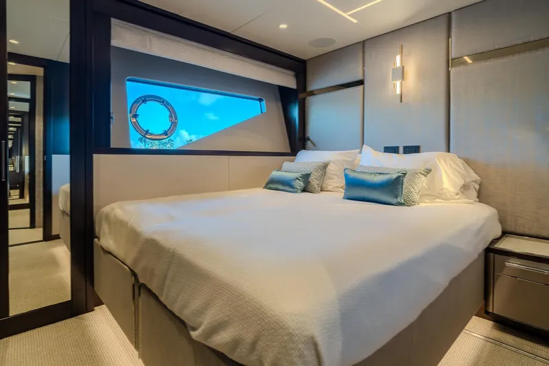 Ramaya 4 Yacht Photos Pics Luxurious bedroom interior of 2023 Sunseeker 88 Yacht with elegant decor and ocean view.