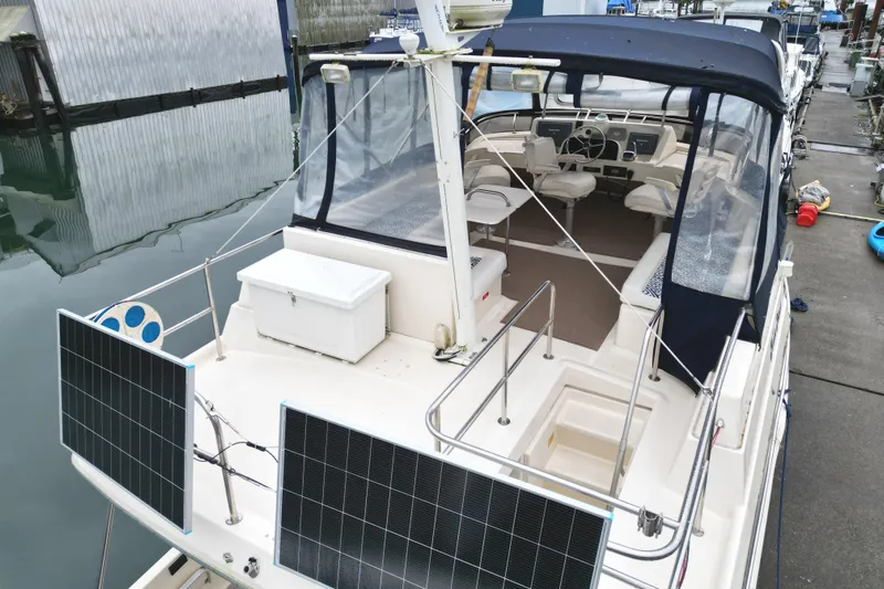 Hula Moon Yacht Photos Pics 2006 Mainship 34 Trawler with solar panels docked at marina.