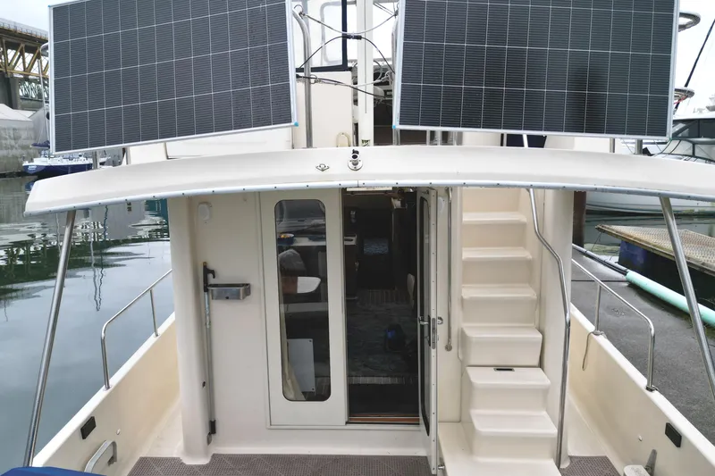 Hula Moon Yacht Photos Pics 2006 Mainship 34 Trawler with solar panels, docked at marina.