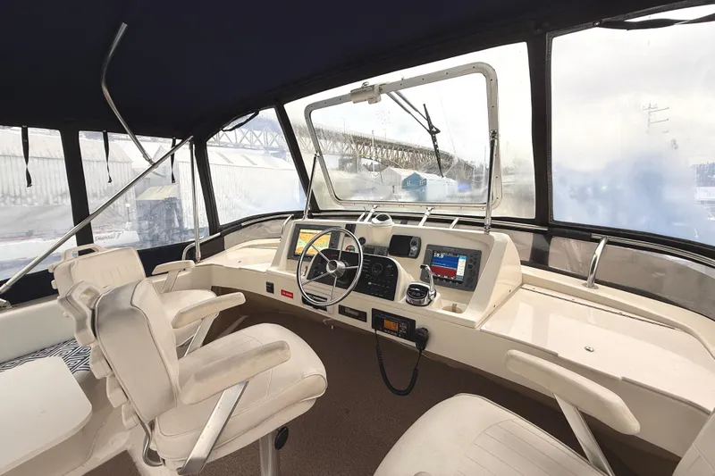 Hula Moon Yacht Photos Pics 2006 Mainship 34 Trawler helm with navigation equipment and comfortable seating.