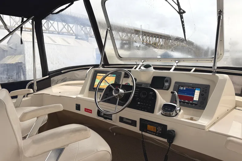 Hula Moon Yacht Photos Pics 2006 Mainship 34 Trawler helm with navigation equipment and bridge view.
