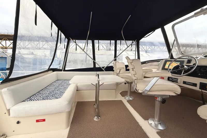 Hula Moon Yacht Photos Pics 2006 Mainship 34 Trawler interior with seating, helm, and navigation equipment.